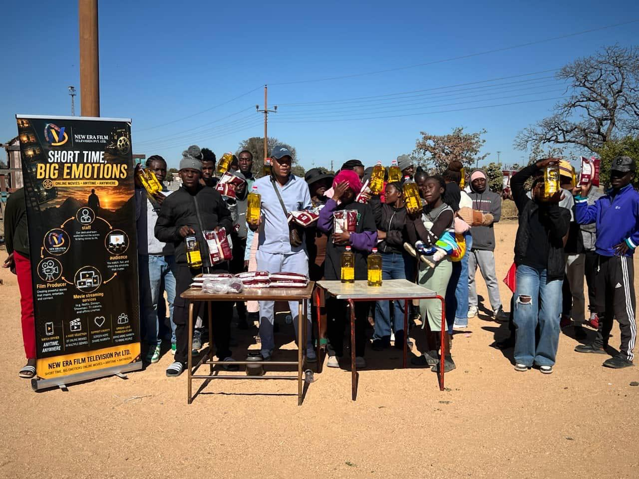 Community members receiving NEF food and oil supplies
