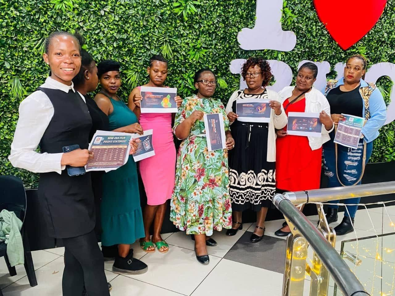 NEF members showcasing promotional documents together