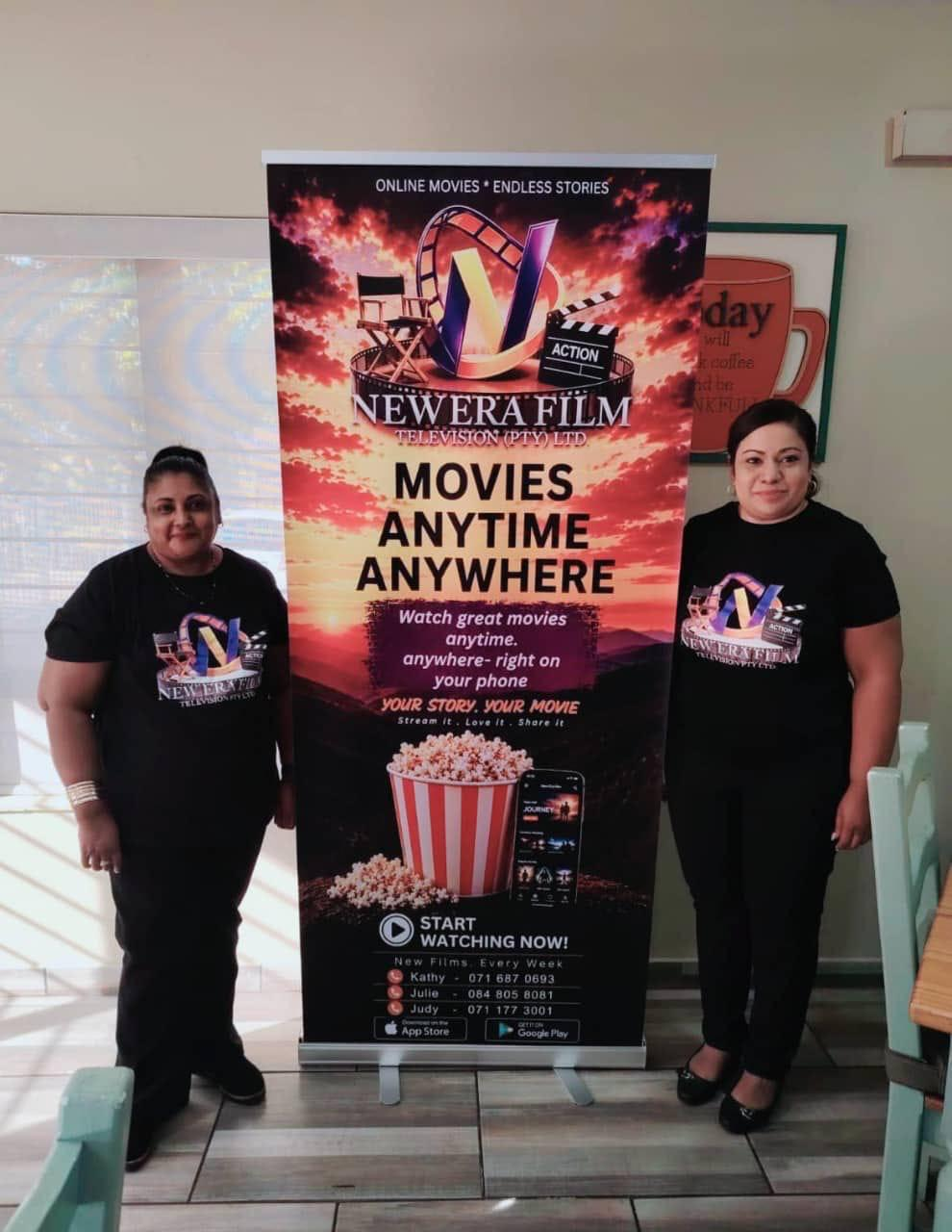 NEF promoters beside the New Era Film roll-up banner