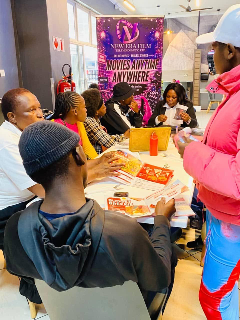Members reviewing NEF promotional materials